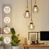 A set of three pendant lights hanging in a room, with icons on the left indicating features. Voir les images du produit