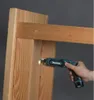 A hand is using a Makita cordless screwdriver to screw into a wooden beam. Podgląd zdjęcia produktu