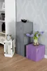 A corner of a room with decorative wooden blocks and a lantern. Voir les images du produit