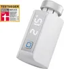 A white smart home radiator thermostat with a digital display and a test winner badge. Produktbild-Vorschau