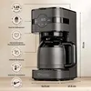 A coffee maker on a wooden surface, with product feature callouts. Produktbild-Vorschau