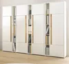 A white and wood-colored shelving unit with books and binders. Produktbild-Vorschau