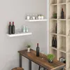 A modern interior scene with shelves and a table displaying various items. Produktbild-Vorschau