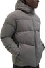 A person wearing a gray puffer jacket. Produktbild-Vorschau