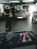 Mechanics in a garage with cars and tools. Produktbild-Vorschau
