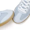 A close-up view of two light blue and white sneakers. Produktbild-Vorschau