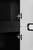 A close-up view of a cabinet hinge and a screwdriver being used to adjust it. Náhľad obrázku produktu