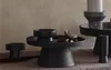 A collection of black ceramic candle holders and decorative bowls arranged on a textured surface. Produktbild-Vorschau