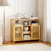 A wooden cabinet with shelves and doors, decorated with various items, in a room with a lamp and curtains. Podgląd zdjęcia produktu