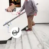 An elderly man is walking down a marble staircase, holding onto a silver handrail. There are diagrams showing how the handrail is attached and how it can be gripped. Produktbild-Vorschau