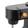 A close-up view of a black sewing machine, focusing on the thread tension dial and guides. Náhled obrázku produktu