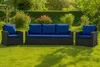 Outdoor furniture set on a lawn with bushes and trees in the background. Produktbild-Vorschau