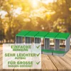 A multi-compartment chicken nesting box with a green roof, placed on a wooden surface with a blurred outdoor background. Produktbild-Vorschau