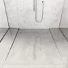 A close-up view of a modern shower floor with a linear drain. Produktbild-Vorschau
