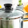 A close-up shot of a steaming pot with a glass lid. Produktbild-Vorschau