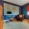 A home office with a large world map on the wall, a computer desk with a monitor and keyboard, a leather armchair, and a wooden cabinet. Anteprima dell’immagine prodotto