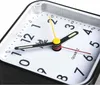 A close-up view of a black analog alarm clock with a white face and black numbers. Produktbild-Vorschau