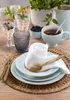 A table setting with plates, cutlery, glasses, and a pitcher, suggesting a meal or gathering. Produktbild-Vorschau