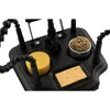 A close-up view of a black soldering helping hand tool with a magnifying glass, a sponge, and a brass cleaning ball. Produktbild-Vorschau