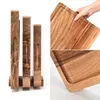 A collage of images showing a set of wooden cutting boards with a holder, close-ups of the wood grain and a hand holding one of the boards. Produktbild-Vorschau