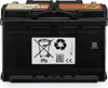A black car battery with various labels and symbols on its side. Produktbild-Vorschau