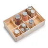 A wooden organizer tray filled with jars of various grains and legumes, placed on a white background. Náhled obrázku produktu