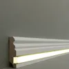 A close-up shot of a white MDF skirting board with an integrated LED light strip. Produktbild-Vorschau