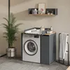 A laundry room with a washing machine, a changing table unit, and a plant. Voir les images du produit