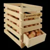 A wooden crate filled with onions, with a pull-out drawer at the bottom also containing onions. Produktbild-Vorschau