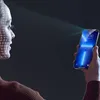 A woman's face is scanned by a smartphone using facial recognition technology. Podgląd zdjęcia produktu