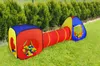 A children's play tent and tunnel set with balls, placed on a grassy lawn with a hedge in the background. Podgląd zdjęcia produktu