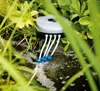 A pond aerator with multiple tubes submerged in water, surrounded by lush green foliage. Produktbild-Vorschau