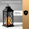 A black lantern with an LED candle inside, placed on a white surface against a gray and gold background. Text overlays highlight product features. Produktbild-Vorschau