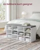 A storage bench with a cushioned top is placed in front of a bed in a bedroom. The bench is filled with folded clothes and storage boxes. Produktbild-Vorschau
