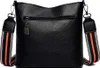 A black leather handbag with a striped strap is shown from the back. Náhľad obrázku produktu
