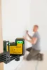 A person is using a laser level to mark a wall. Produktbild-Vorschau