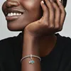 A close-up shot of a woman's arm wearing a Pandora bracelet with charms. Anteprima dell’immagine prodotto