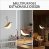 A collage showing a bird-shaped LED lamp in different settings: hanging in a nursery, on a desk, and as a pendant light in a living room. Anteprima dell’immagine prodotto