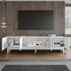A white TV stand with open doors, displaying shelves with books and decorative items, in a living room setting with a wooden wall and a large TV. Anteprima dell’immagine prodotto