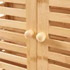Close-up of a wooden cabinet with two round knobs. Produktbild-Vorschau