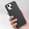 A hand holding a black iPhone 15 case. Produktbild-Vorschau