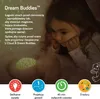 A young girl looking at a plush toy that projects stars. Produktbild-Vorschau