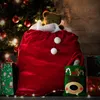 A festive Christmas scene with a large red Santa sack filled with gifts, a teddy bear, and presents under a decorated Christmas tree. Produktbild-Vorschau