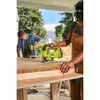 Two people are working on a wooden table outdoors, one using a jigsaw. Produktbild-Vorschau