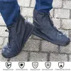 A person wearing blue jeans and black shoe covers on a paved surface. Produktbild-Vorschau