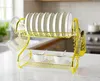 A gold-colored two-tier dish drying rack with plates, cups, and cutlery is displayed on a kitchen counter. Voir les images du produit