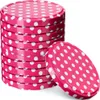A stack of pink polka dot jar lids with one lid placed in front of the stack. Podgląd zdjęcia produktu