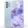 A light blue Samsung Galaxy A13 4G phone is shown next to a clear phone case with a purple marble pattern. Produktbild-Vorschau
