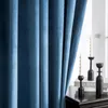 A close-up view of blue velvet curtains with decorative candles and candlesticks on a dark wooden surface. Voir les images du produit