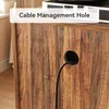 A close-up view of a wooden cabinet with a cable management hole and a black cable passing through it. Text overlay indicates 'Cable Management Hole'. Produktbild-Vorschau